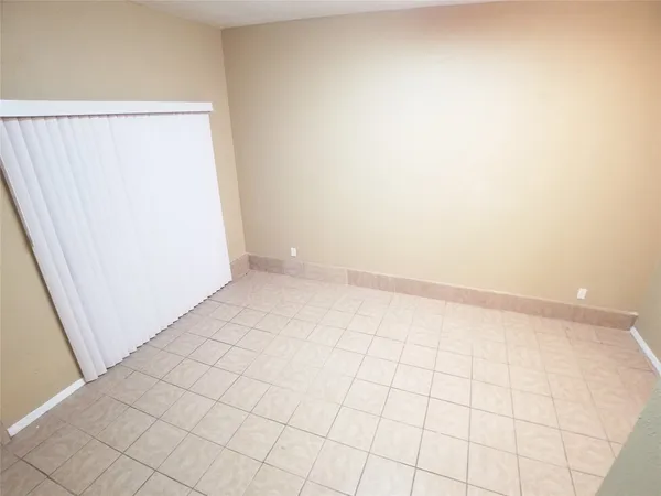 an empty room with white walls and tiles