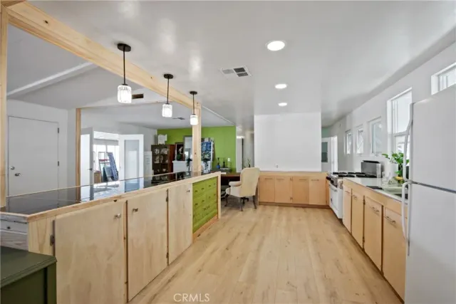 a large white kitchen with stainless steel appliances