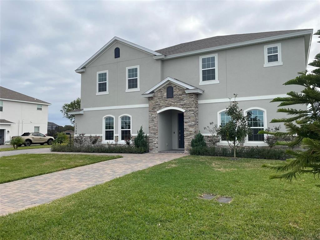 17708 Sawgrass Run Tavares, FL 32778 - Photo 1 of 79 a front view of a house with a garden and plants