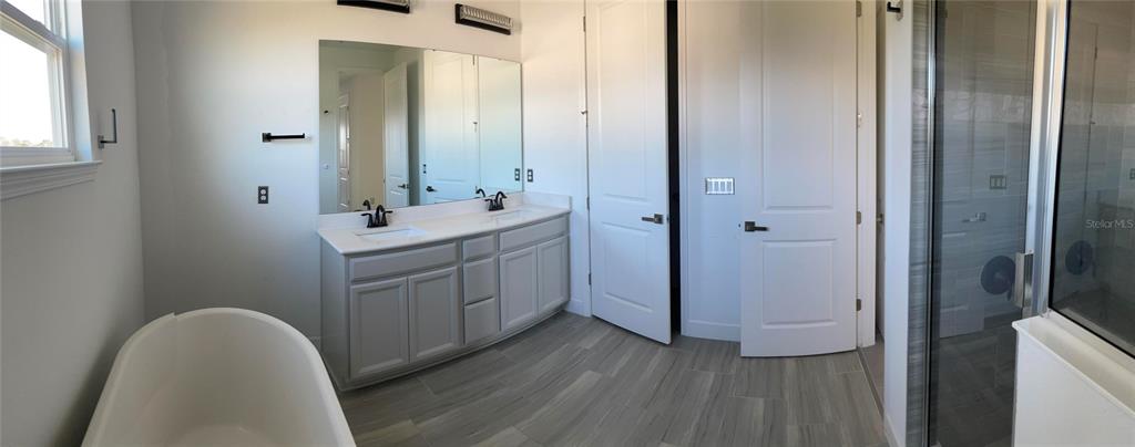 17708 Sawgrass Run Tavares, FL 32778 - Photo 45 of 79 a bathroom with a sink and a mirror