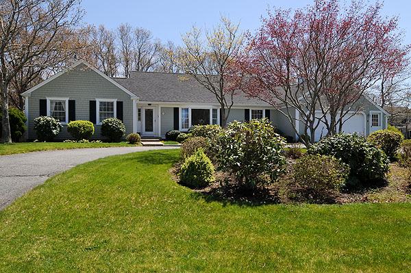 6 East Crossfield Road Sandwich, MA 02644 - Photo 1 of 3 a front view of a house with a yard and trees