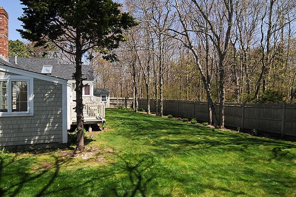 6 East Crossfield Road Sandwich, MA 02644 - Photo 3 of 3 a backyard of a house with lots of green space