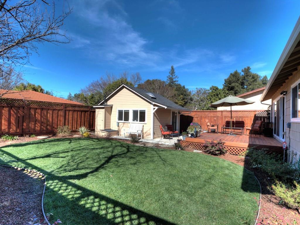 a front view of a house with a yard and trees