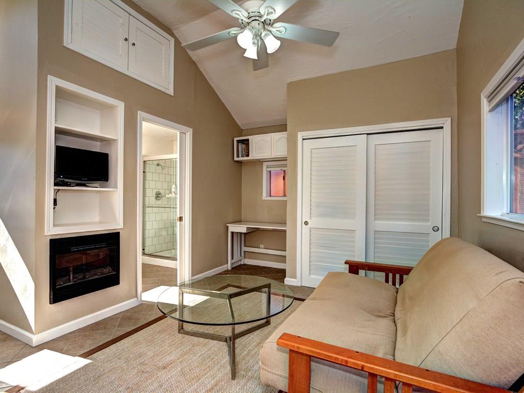 659 Marsh Road Menlo Park, CA 94025 - Photo 15 of 16 a living room with furniture a flat screen tv and a fireplace