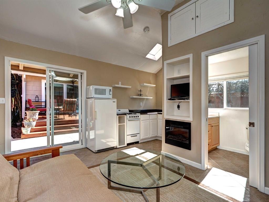659 Marsh Road Menlo Park, CA 94025 - Photo 16 of 16 a living room with furniture a fireplace and a flat screen tv