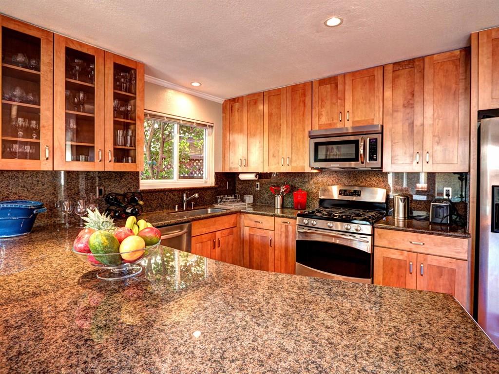 659 Marsh Road Menlo Park, CA 94025 - Photo 6 of 16 a kitchen with stainless steel appliances granite countertop a stove sink microwave and refrigerator