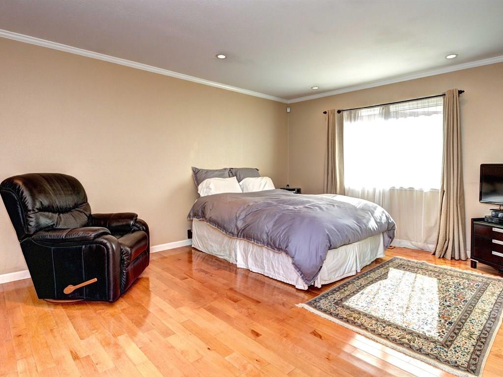 659 Marsh Road Menlo Park, CA 94025 - Photo 8 of 16 a spacious bedroom with a bed and a couch