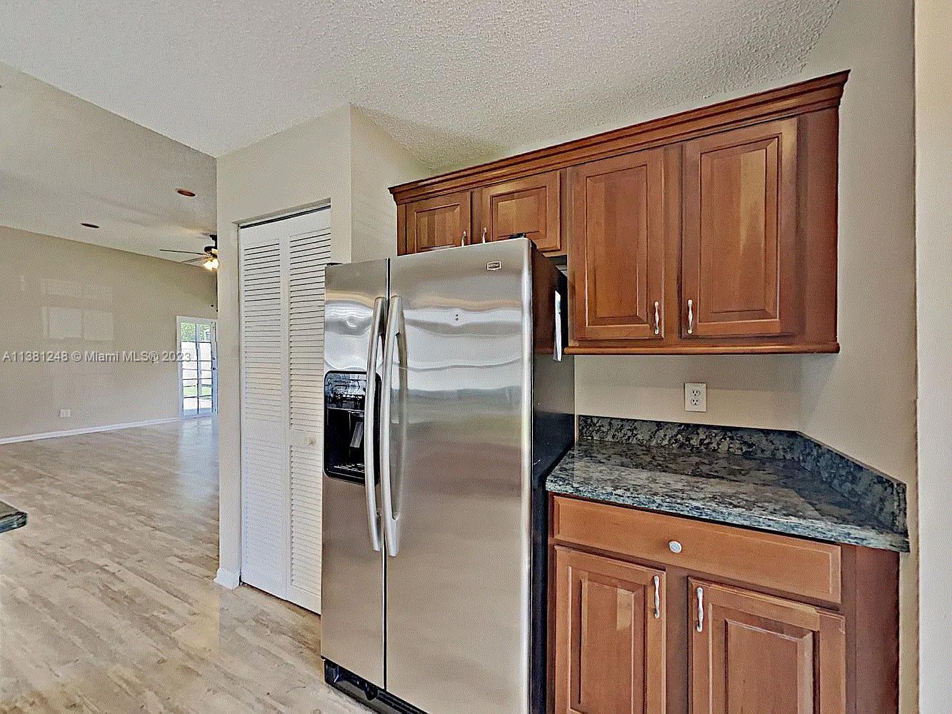 Silver Lakes Miramar, FL 33029 - Photo 11 of 17 a kitchen with granite countertop stainless steel appliances a refrigerator and cabinets