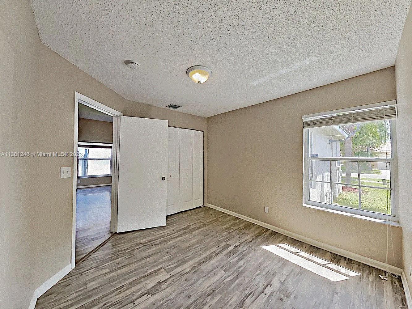 Silver Lakes Miramar, FL 33029 - Photo 14 of 17 a view of an empty room with wooden floor and a window