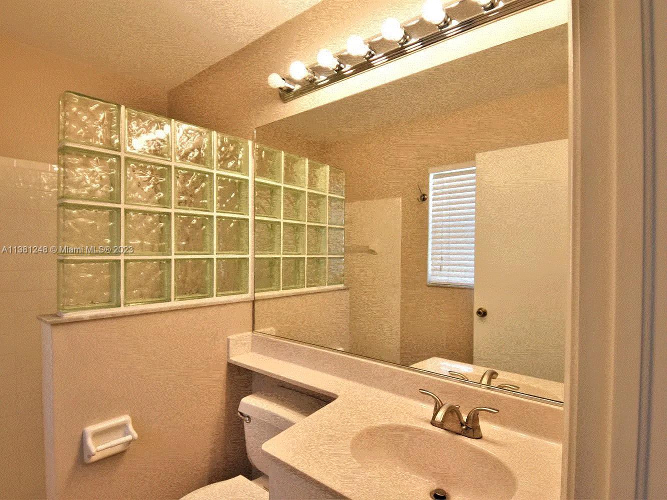Silver Lakes Miramar, FL 33029 - Photo 15 of 17 a bathroom with a sink and a mirror
