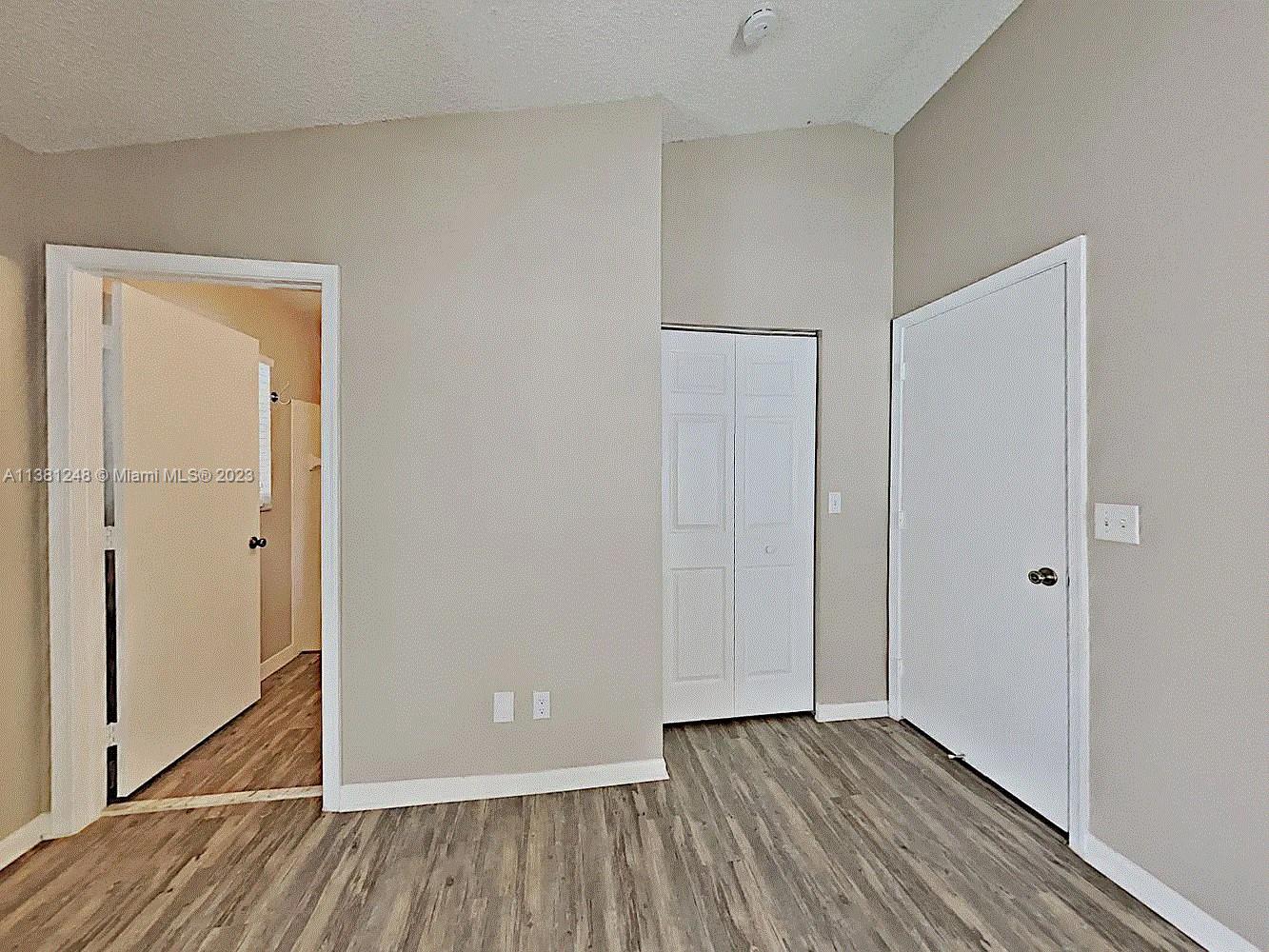 Silver Lakes Miramar, FL 33029 - Photo 16 of 17 a view of an empty room with wooden floor