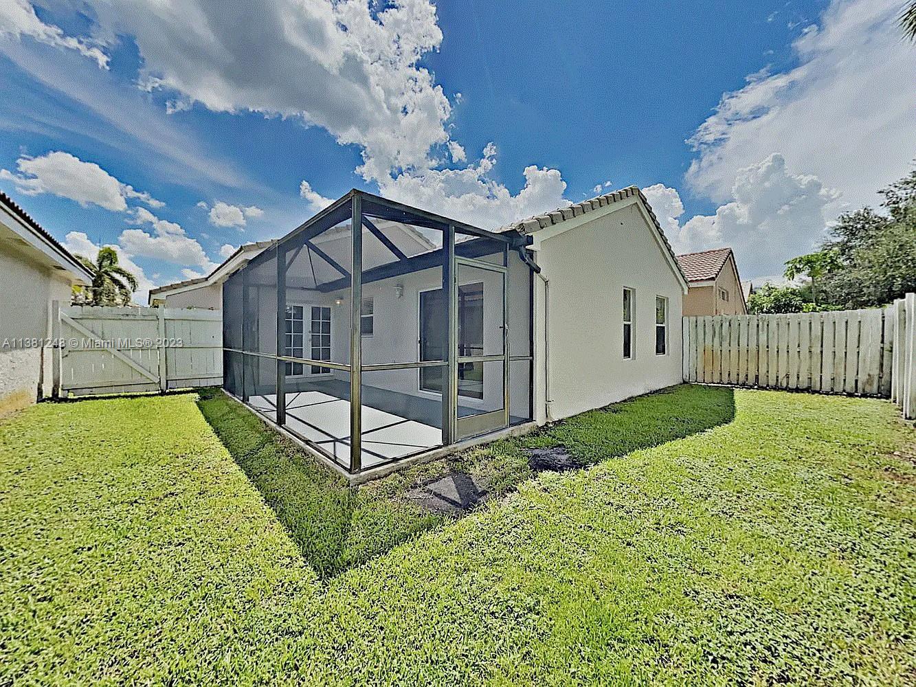 Silver Lakes Miramar, FL 33029 - Photo 2 of 17 a view of a house with a yard