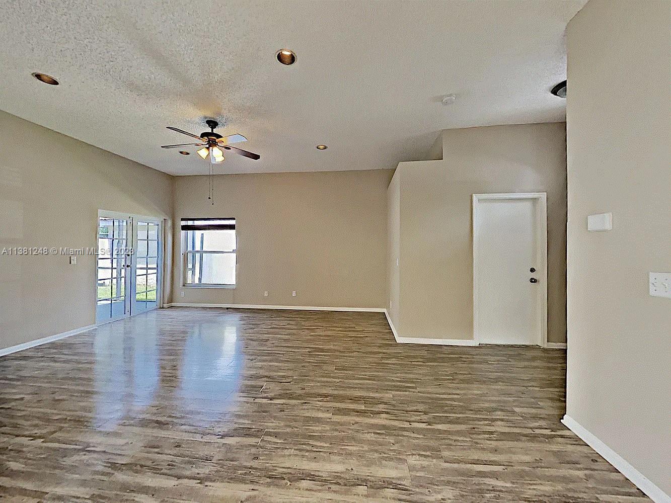 Silver Lakes Miramar, FL 33029 - Photo 6 of 17 a view of an empty room with window and wooden floor