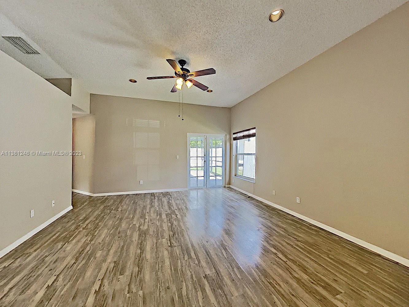 Silver Lakes Miramar, FL 33029 - Photo 7 of 17 a view of empty room with wooden floor and fan