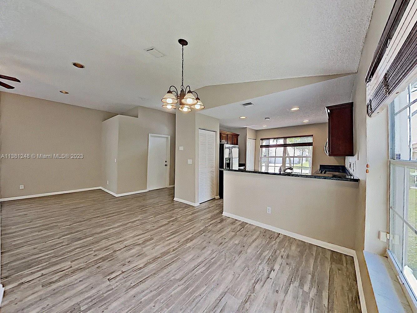 Silver Lakes Miramar, FL 33029 - Photo 8 of 17 a view of an empty room with window and wooden floor