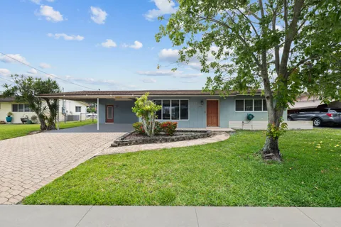 a front view of house with yard and outdoor seating