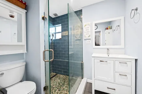 a bathroom with a toilet sink and shower