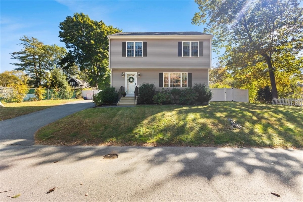 25 Upton Street Hanson, MA 02341 - Photo 2 of 30 a view of a yard in front of a brick house with large windows