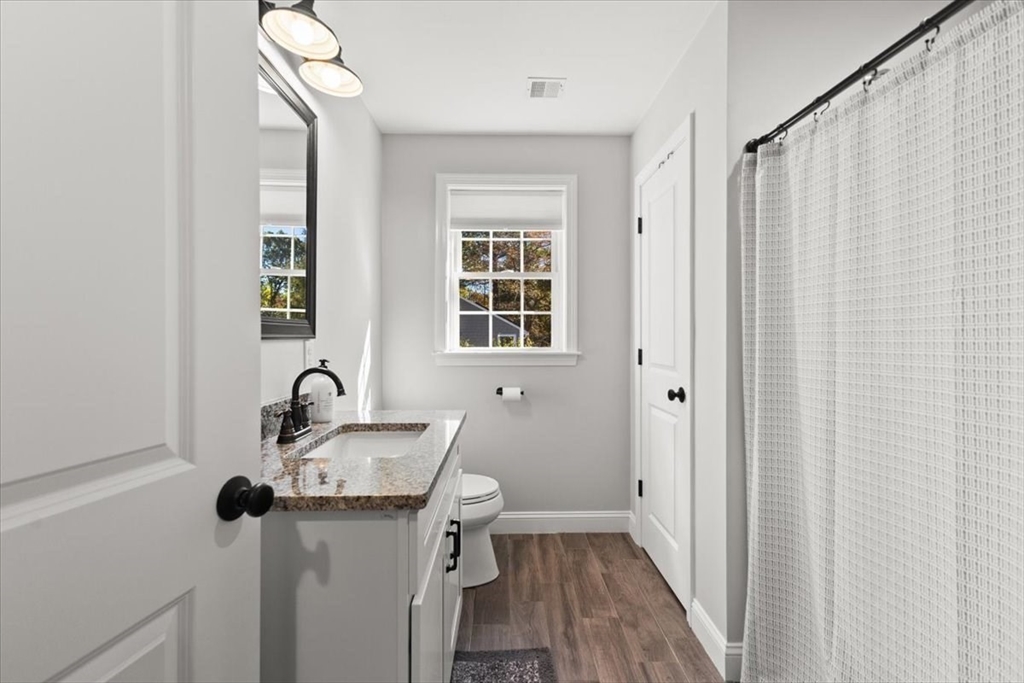 25 Upton Street Hanson, MA 02341 - Photo 21 of 30 a bathroom with a sink and mirror with bathtub