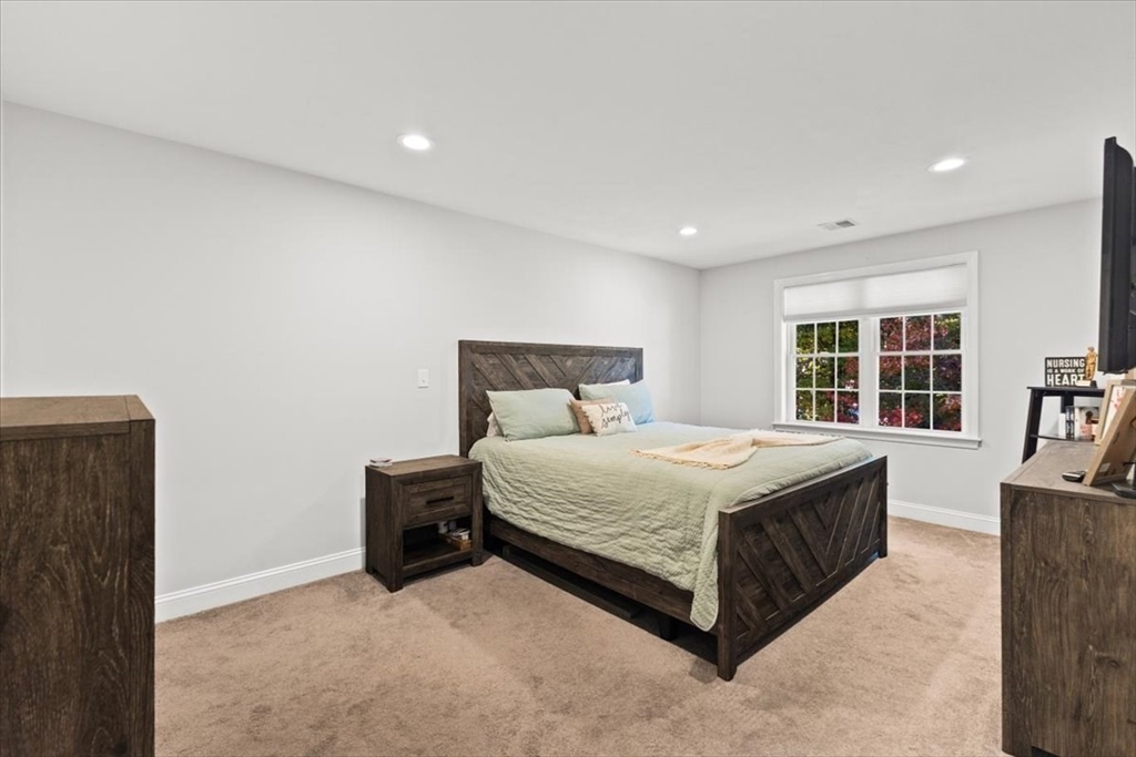 25 Upton Street Hanson, MA 02341 - Photo 22 of 30 a bedroom with a bed and a cabinets