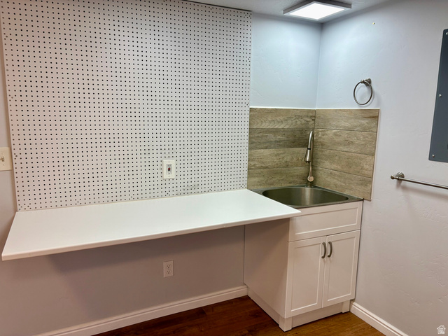665 West State Road Lehi, UT 84043 - Photo 22 of 30 Utility area featuring a stainless steel sink, white shaker-style cabinetry, wood-finish flooring, a wall-mounted pegboard, and a square ceiling light fixture