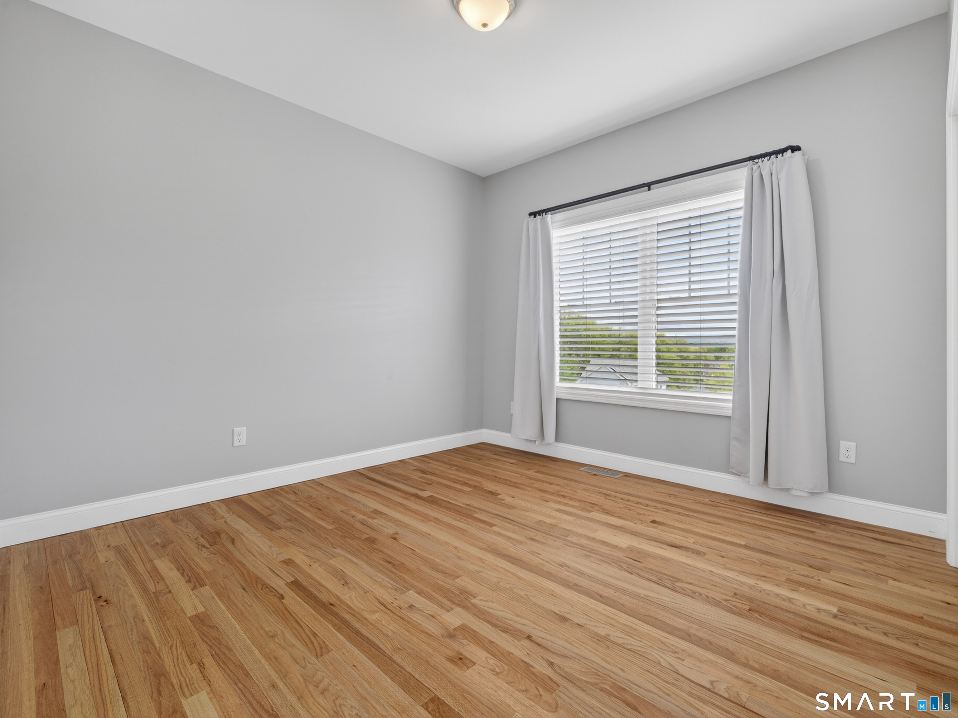 650 Ridgewood Road Middletown, CT 06457 - Photo 23 of 40 a view of an empty room with wooden floor and a window