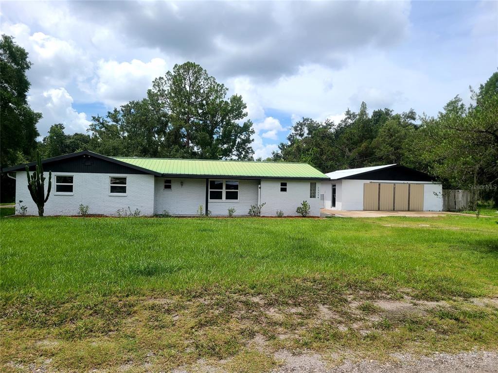 23334 Brandy Road Land O Lakes, FL 34639 - Photo 1 of 1 a view of a house with backyard and garden