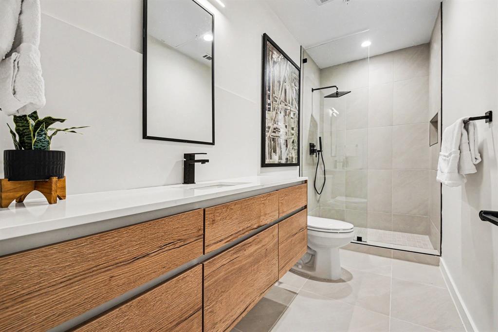 1111 Raiford Road, Unit 121 Carrollton, TX 75007 - Photo 23 of 30 a bathroom with a sink a toilet a mirror and shower