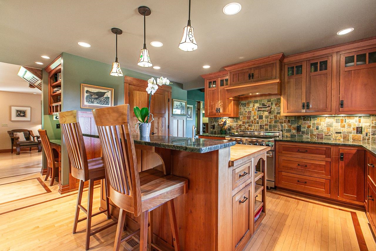 4757 North Hammer Road Scales Mound, IL 61075 - Photo 17 of 95 a kitchen with stainless steel appliances granite countertop a refrigerator a sink dishwasher a dining table and chairs with wooden floor
