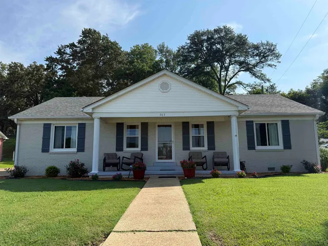 a front view of a house with garden