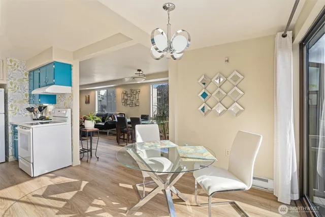 a view of a dining room with furniture and a chandelier