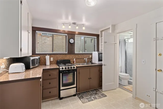 a kitchen with a sink stove and cabinets