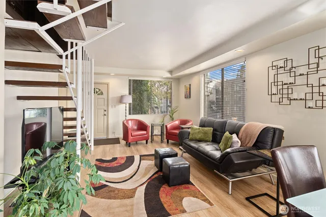 a living room with furniture and a floor to ceiling window
