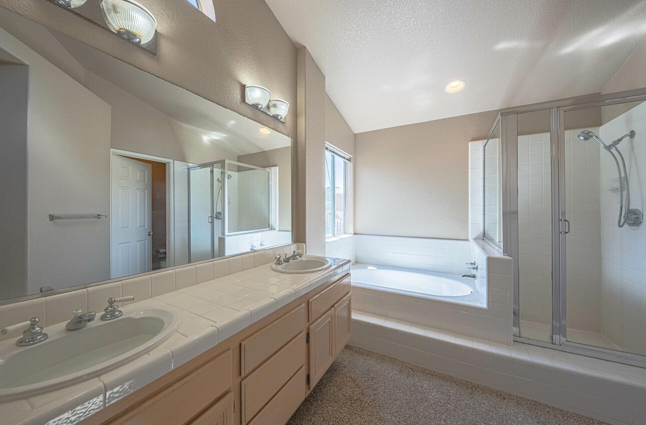 337 Quebrada Del Mar Road Marina, CA 93933 - Photo 34 of 44 a bathroom with a granite countertop sink mirror and a bath tub