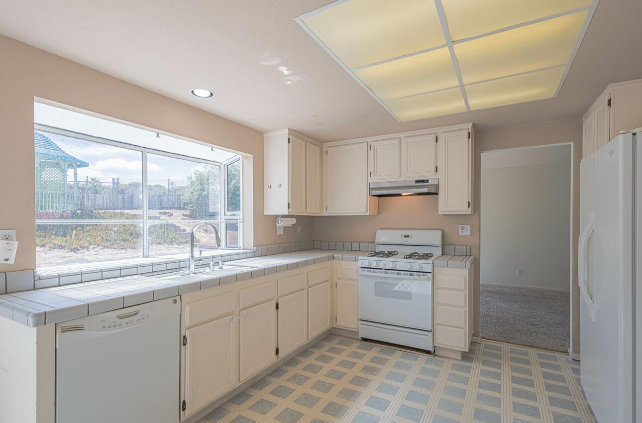 337 Quebrada Del Mar Road Marina, CA 93933 - Photo 8 of 44 a kitchen with a stove a sink and a refrigerator