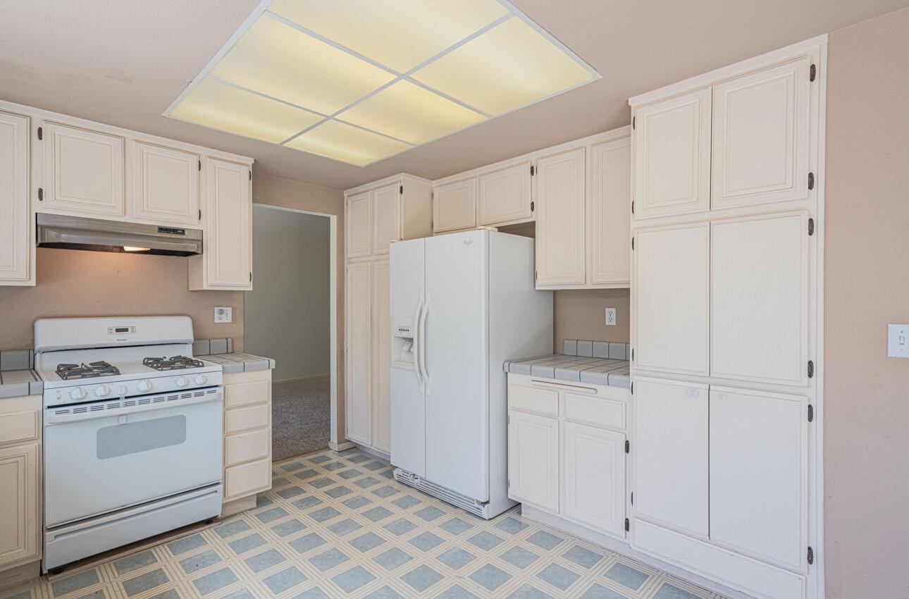 337 Quebrada Del Mar Road Marina, CA 93933 - Photo 9 of 44 a kitchen with white cabinets and white appliances
