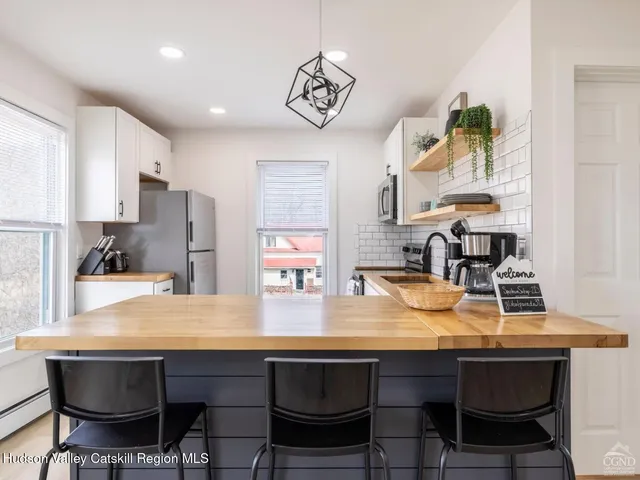 a view of a bedroom with furniture and flat screen tv