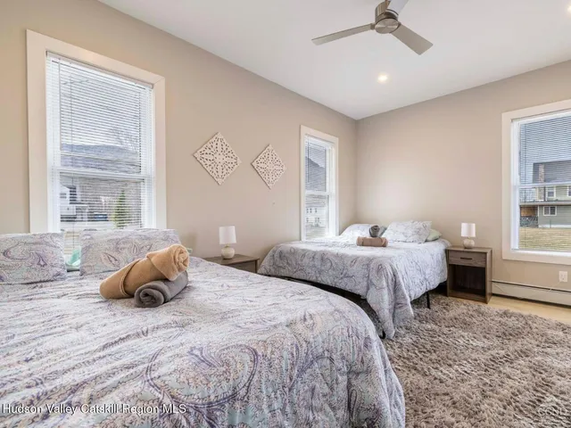 a view of backyard with chairs and iron fence