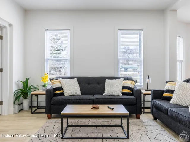 a kitchen with stainless steel appliances granite countertop a sink a stove a refrigerator and island with wooden floor