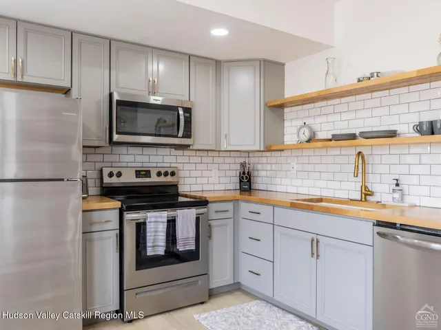 a bedroom with two bed and a window