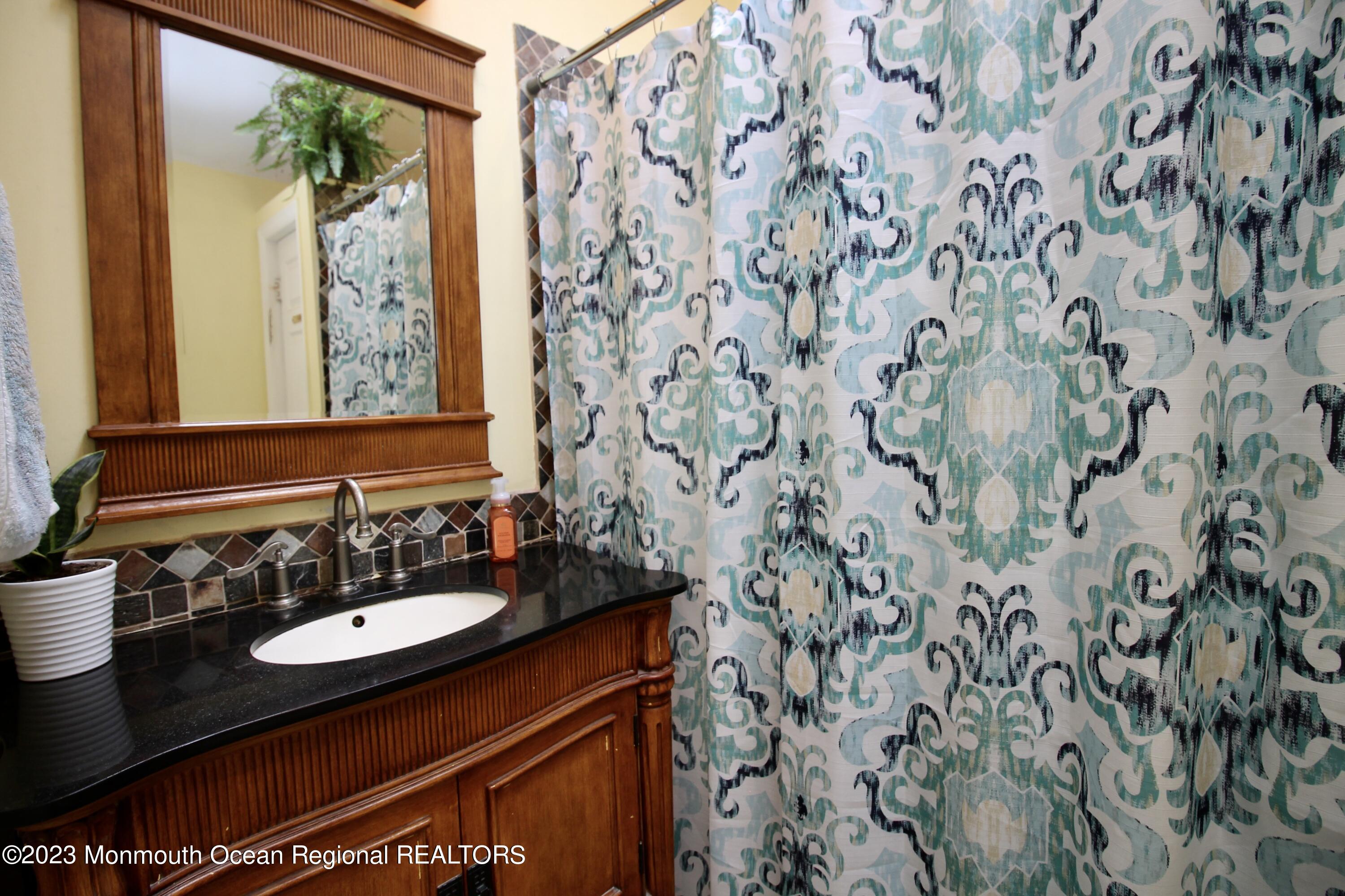 216 Lenape Trail Jackson, NJ 08527 - Photo 23 of 58 a bathroom with a sink and mirror
