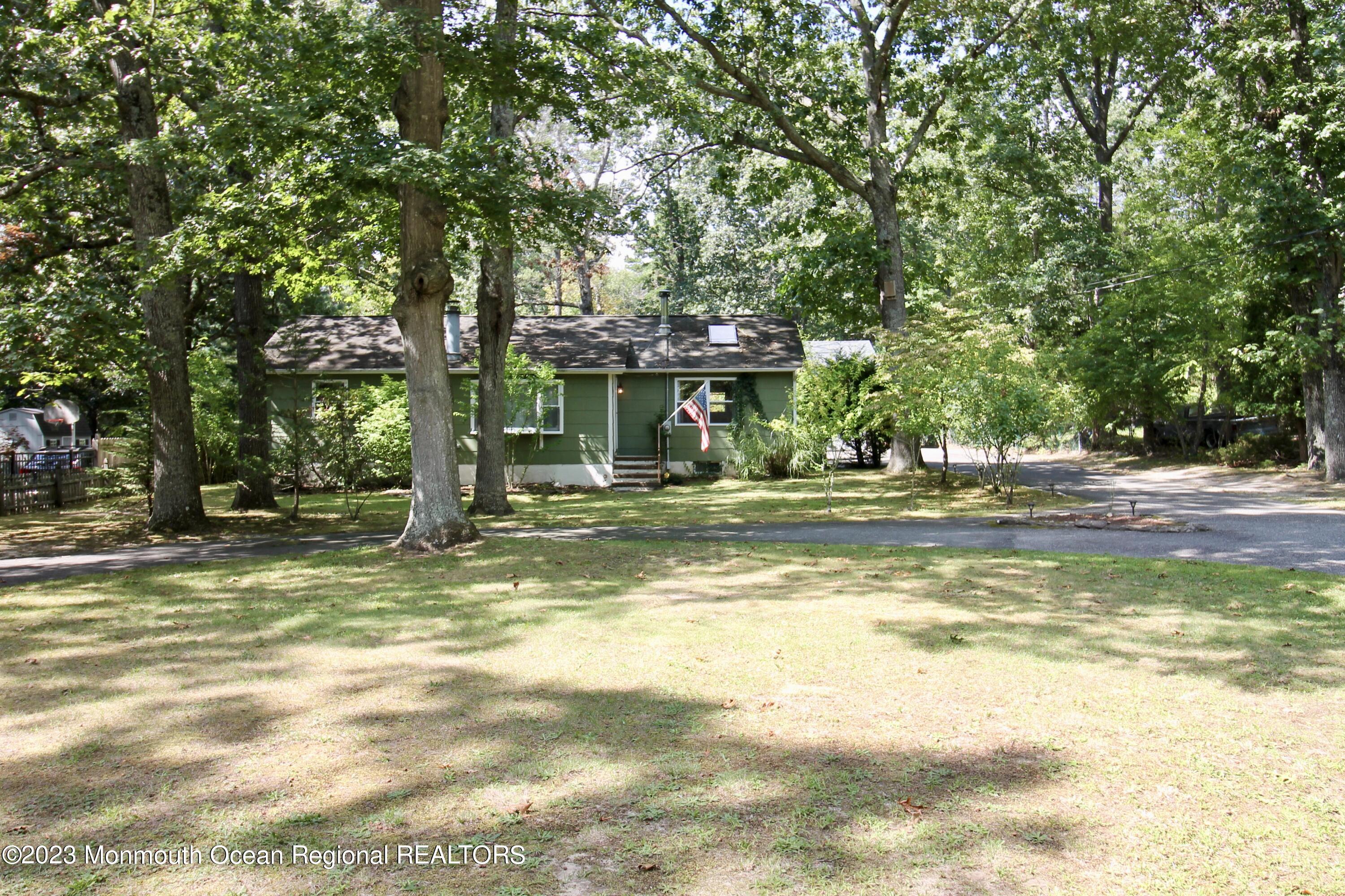 216 Lenape Trail Jackson, NJ 08527 - Photo 3 of 58 a view of swimming pool with lawn chairs and large trees