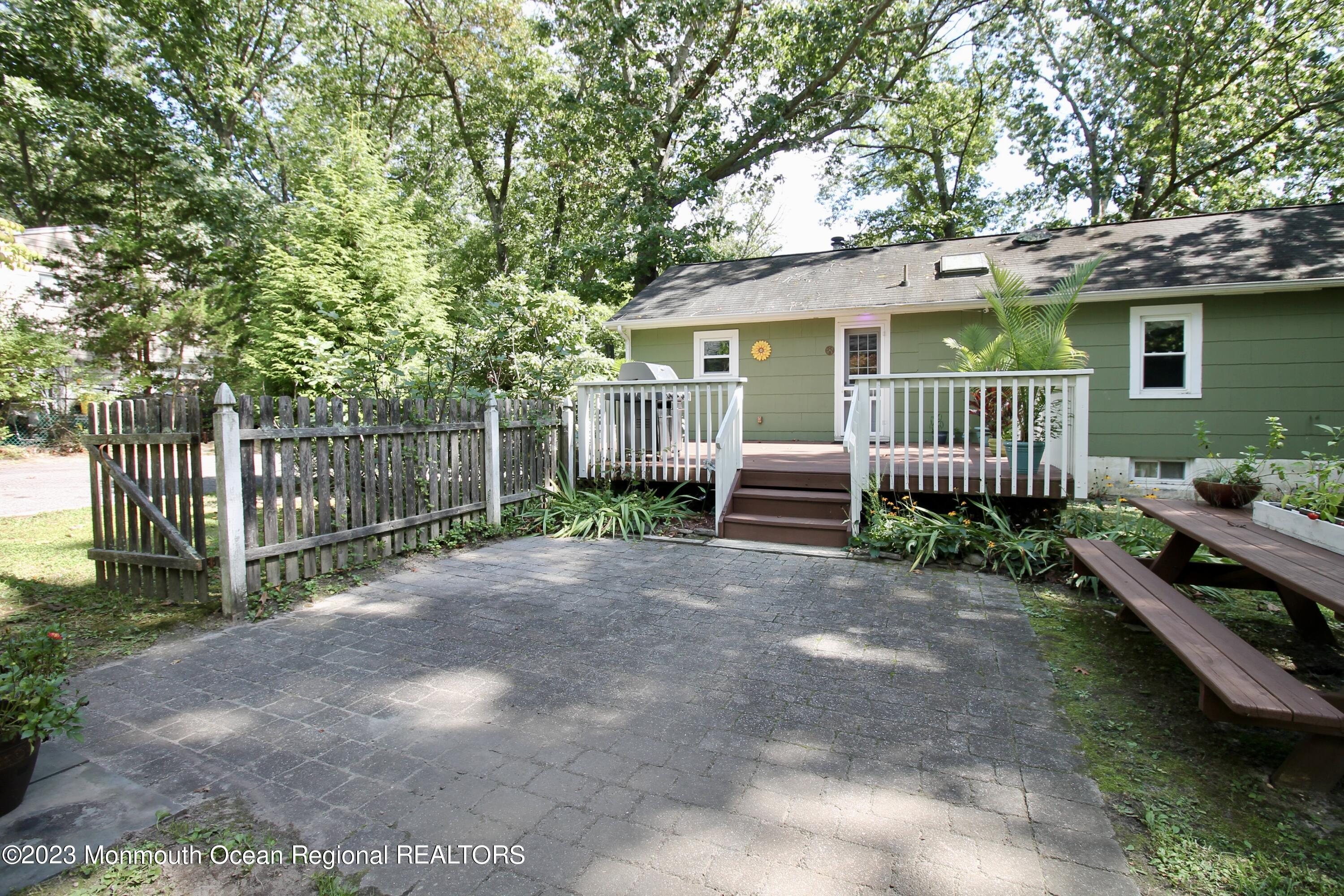 216 Lenape Trail Jackson, NJ 08527 - Photo 42 of 58 a view of a house with wooden fence next to a yard