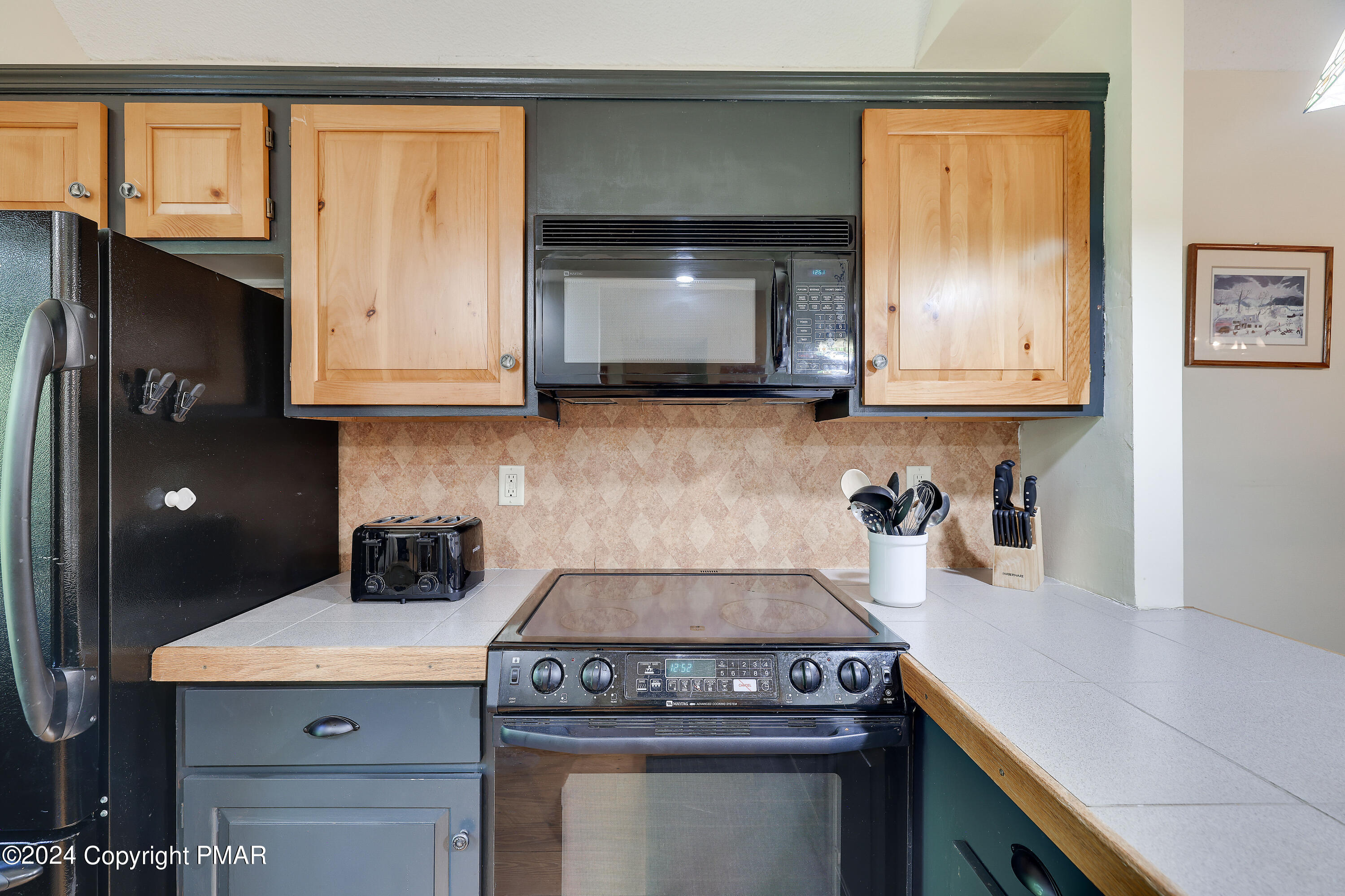84 Short Hill Rd Lake Lake Harmony, PA 18624 - Photo 12 of 38 a kitchen with granite countertop a stove a microwave a sink and cabinets