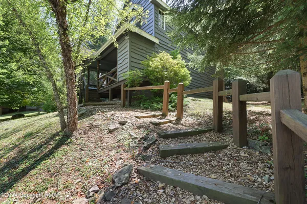 a view of a yard with wooden fence