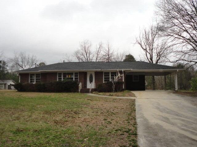 a front view of a house with yard and mountain view