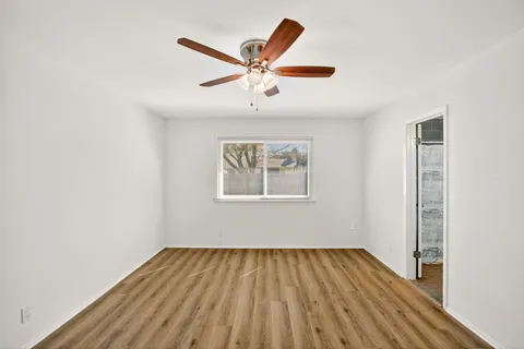 a view of a room with wooden floor and window