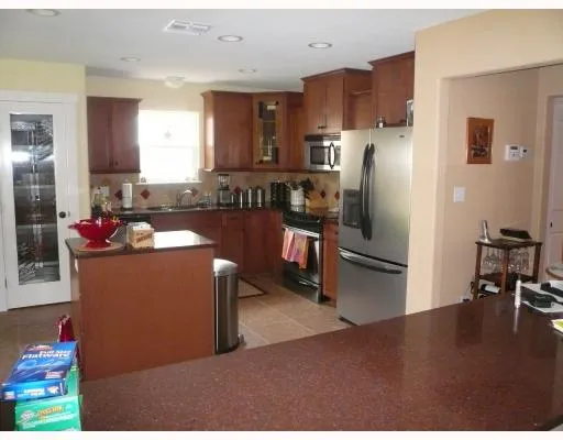 a kitchen with refrigerator and cabinets