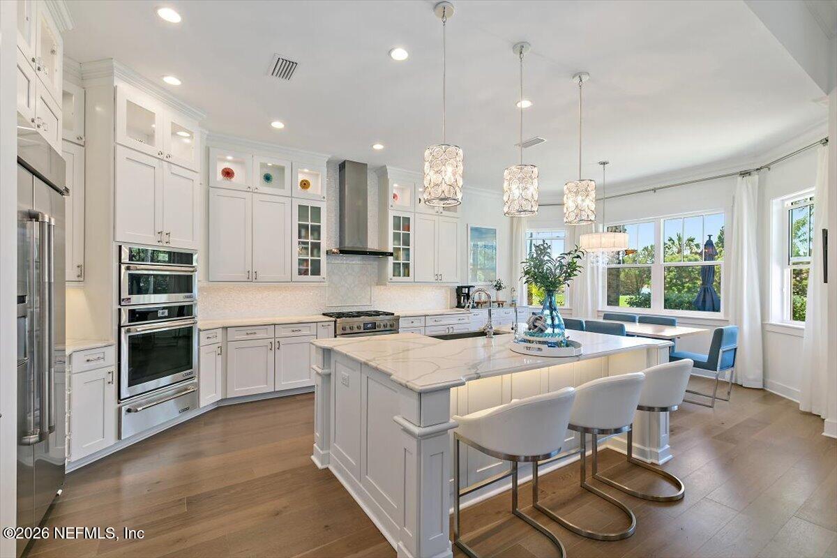 556 Timber Bridge Lane Atlantic Beach, FL 32233 - Photo 19 of 71 a large kitchen with kitchen island a stove a table and chairs in it