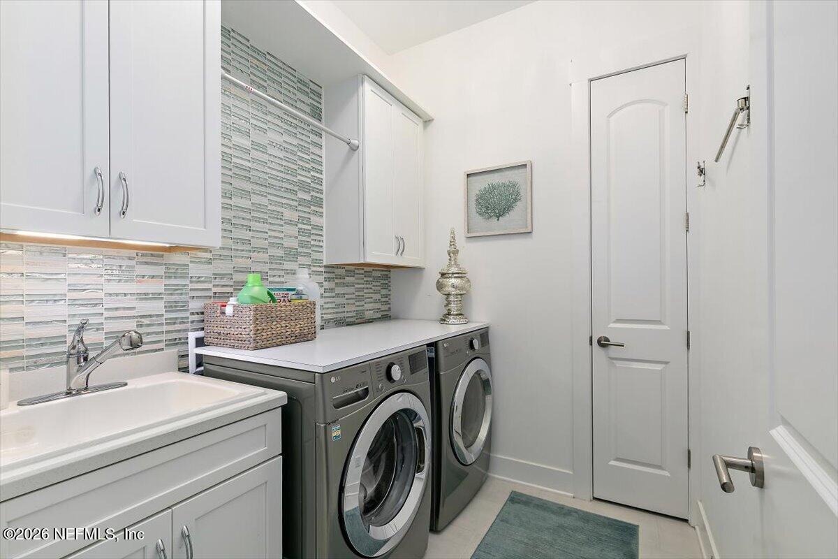 556 Timber Bridge Lane Atlantic Beach, FL 32233 - Photo 36 of 71 a bathroom with a sink a washer and dryer